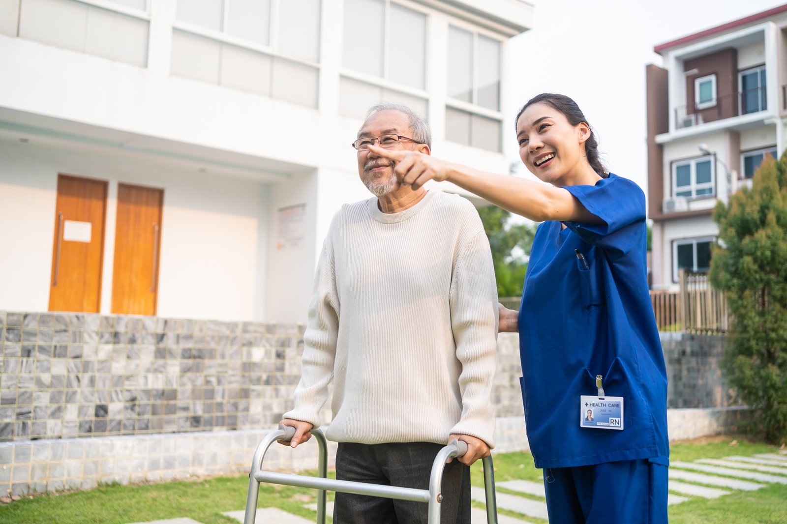 Carer accompanying an older adult outdoors